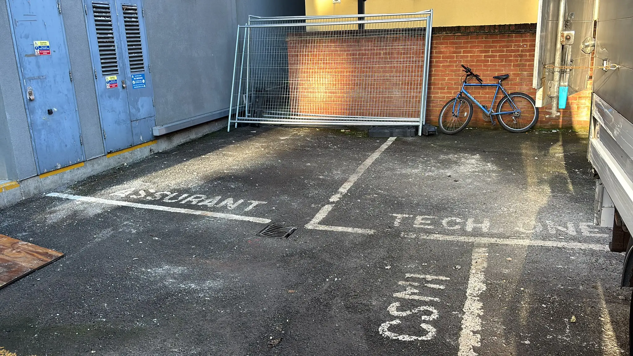 Marked loading and parking area outside a commercial premises.