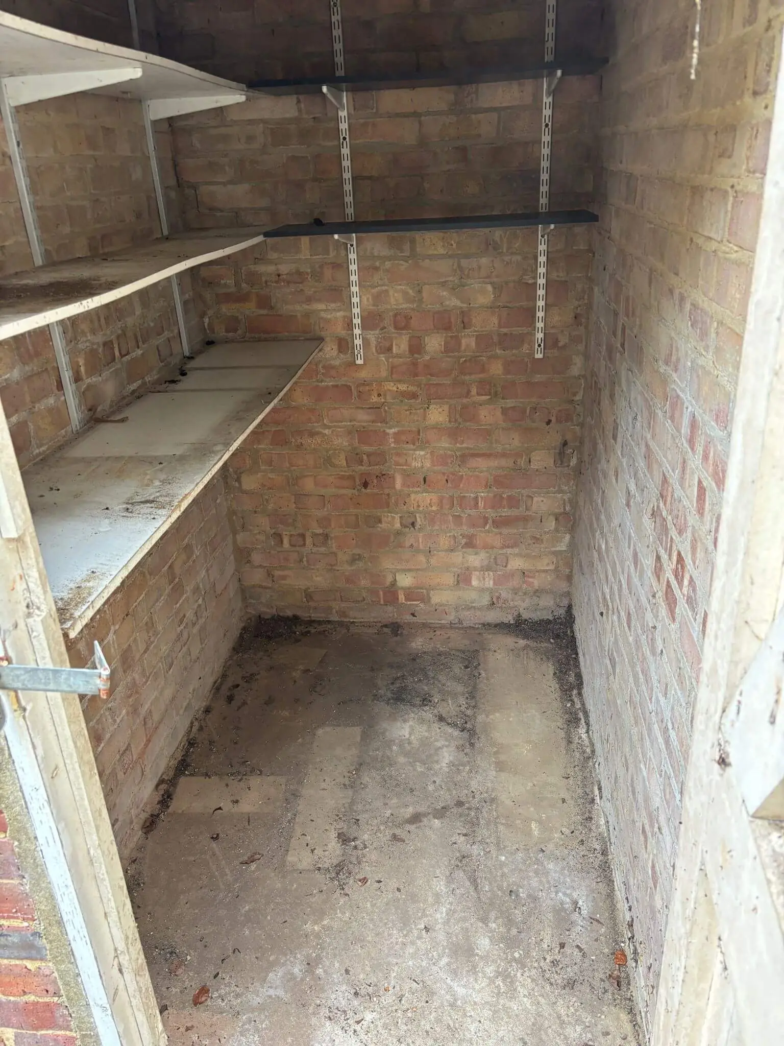 Small brick garage cleared of the bicycle, tyres, electronics and stored items.