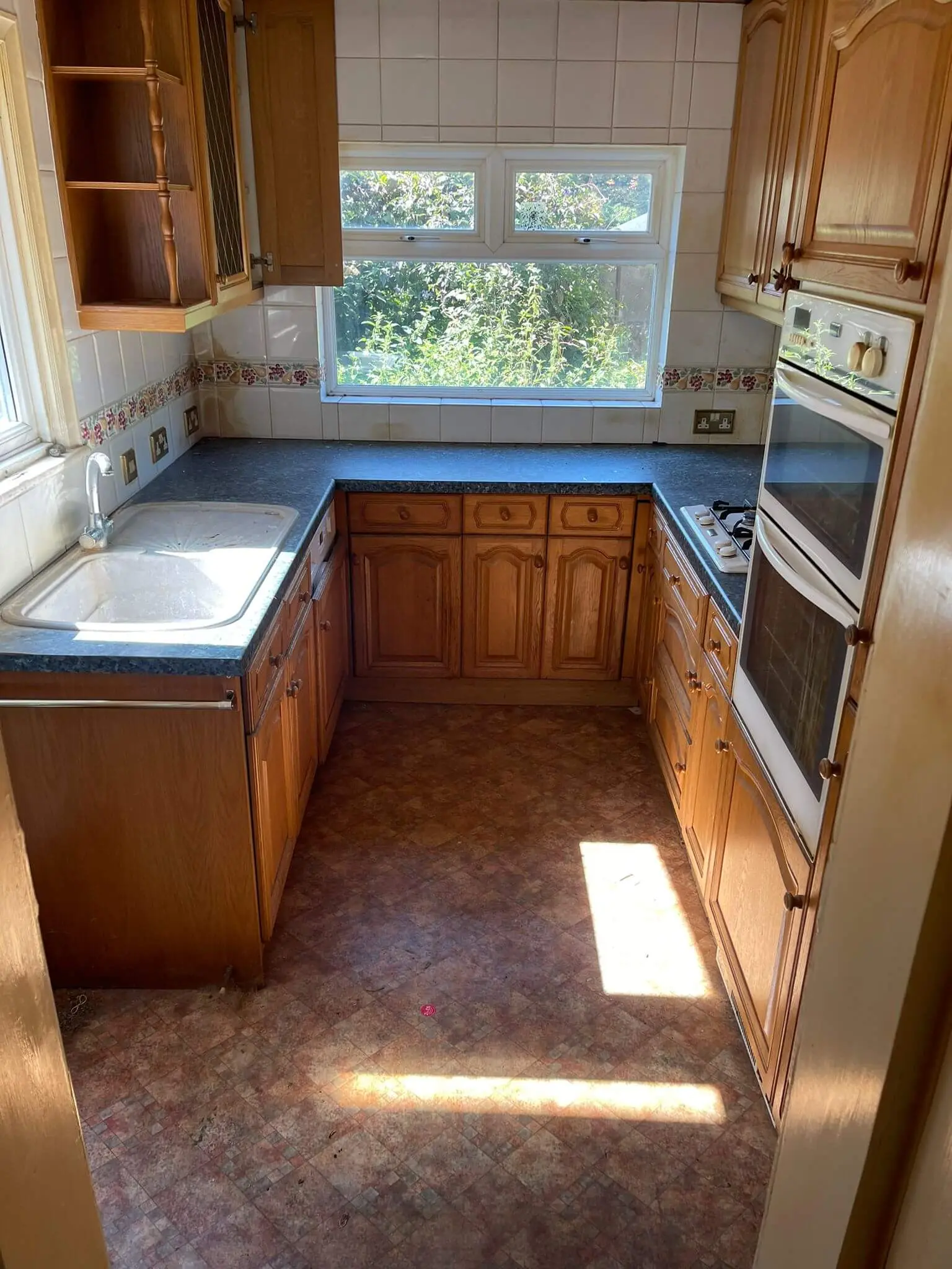 Kitchen cleared of loose household items and rubbish.