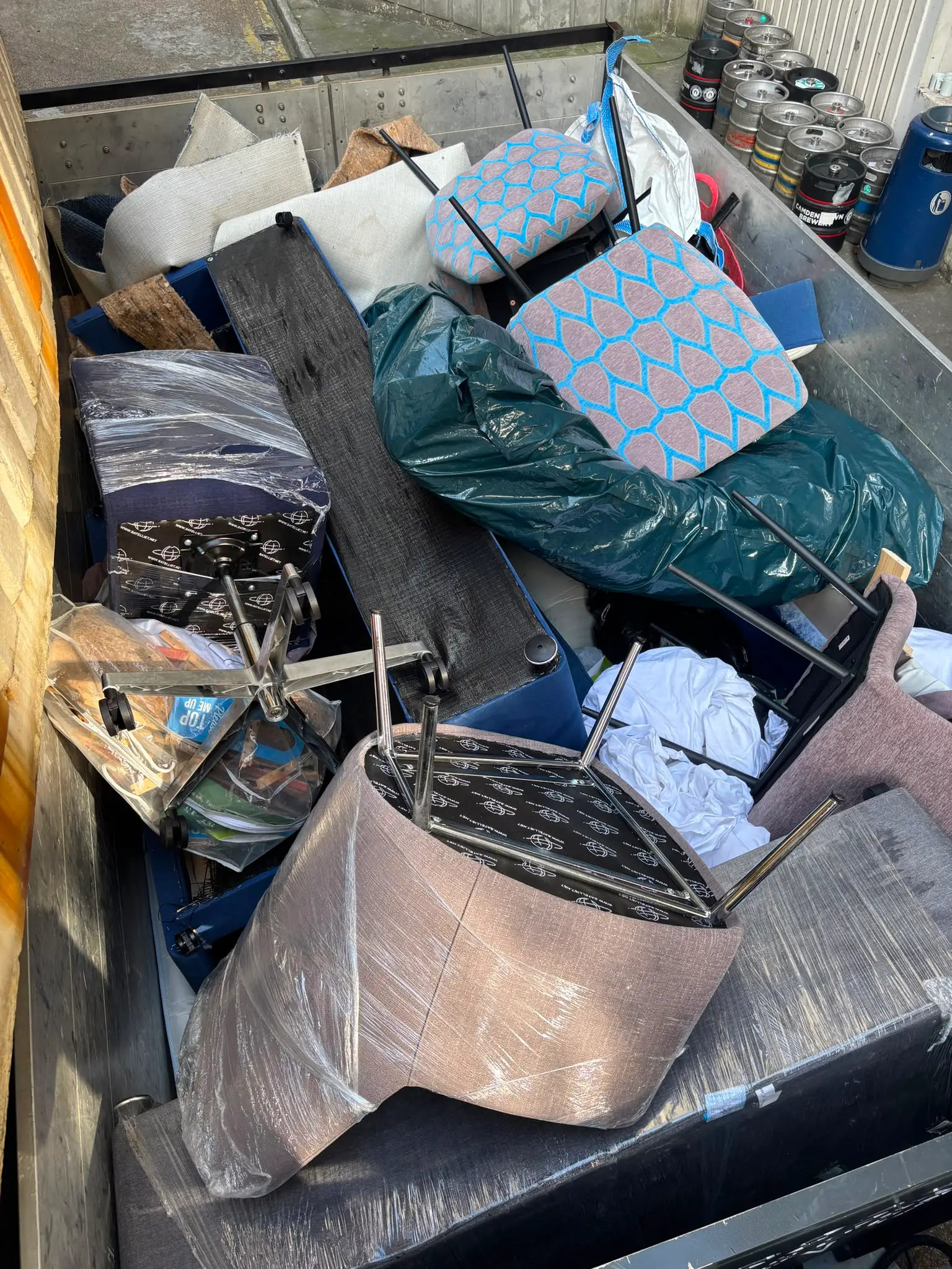 Mixed waste loaded on the tipper Mixed furniture, mattresses and bagged waste loaded onto the tipper body during a clearance.