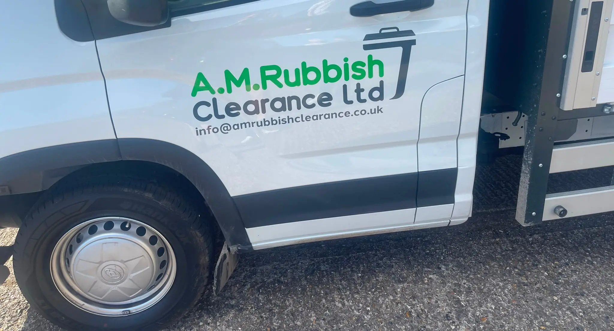 AM Rubbish Clearance branded van parked on a residential street.