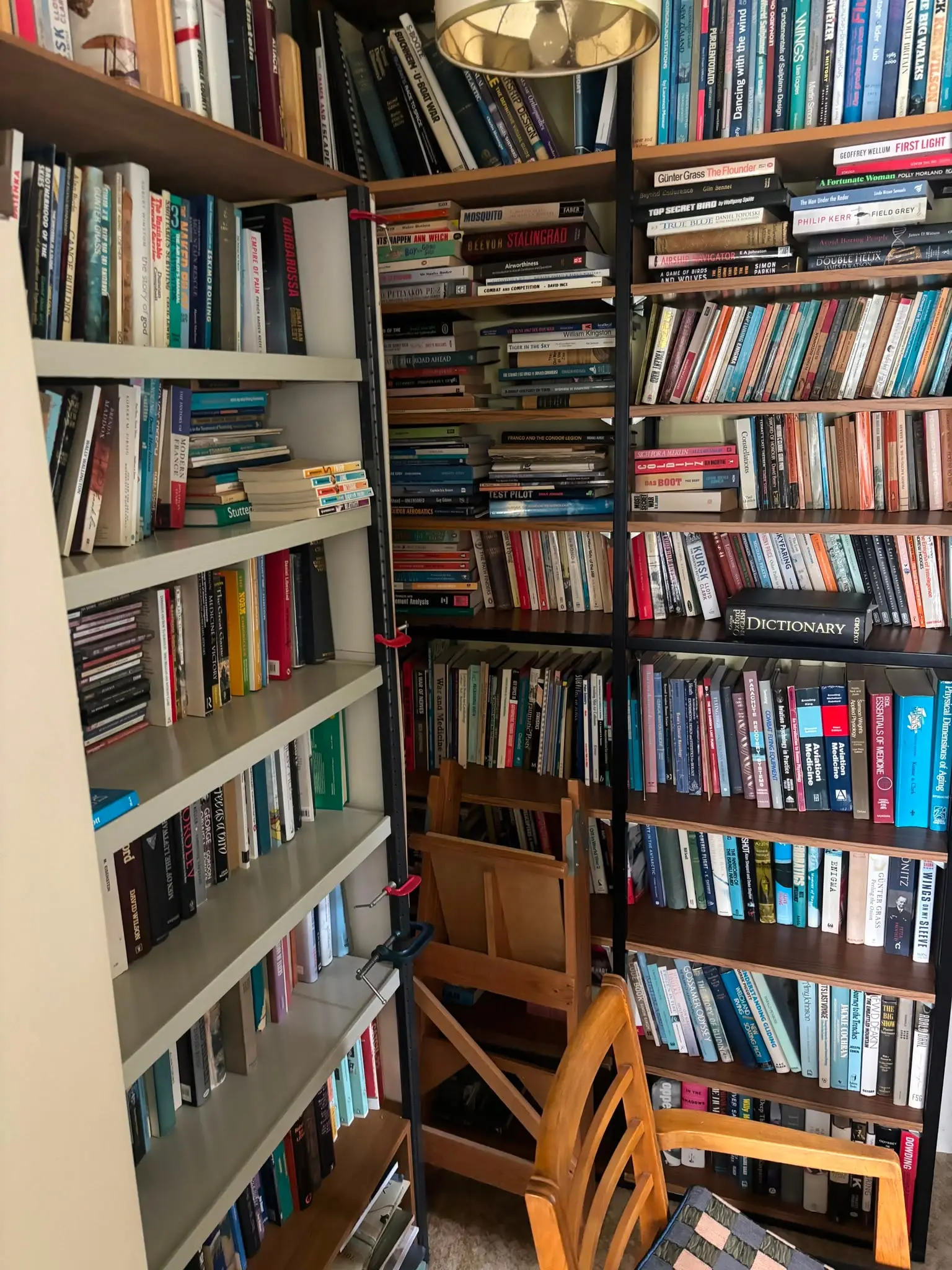 Room filled with books and shelving before a flat clearance.