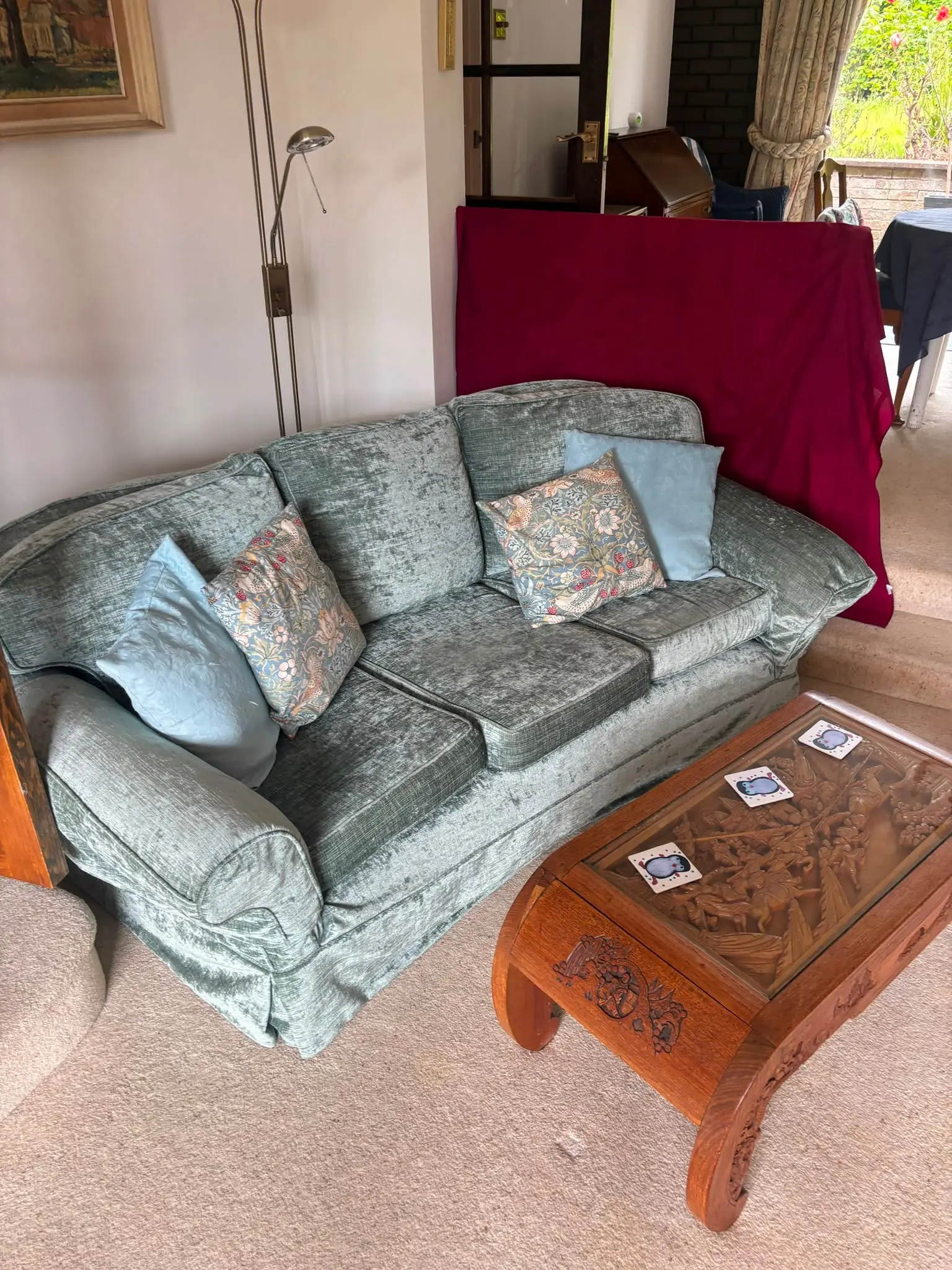 Sofa and household furniture in a lounge ahead of a house clearance.