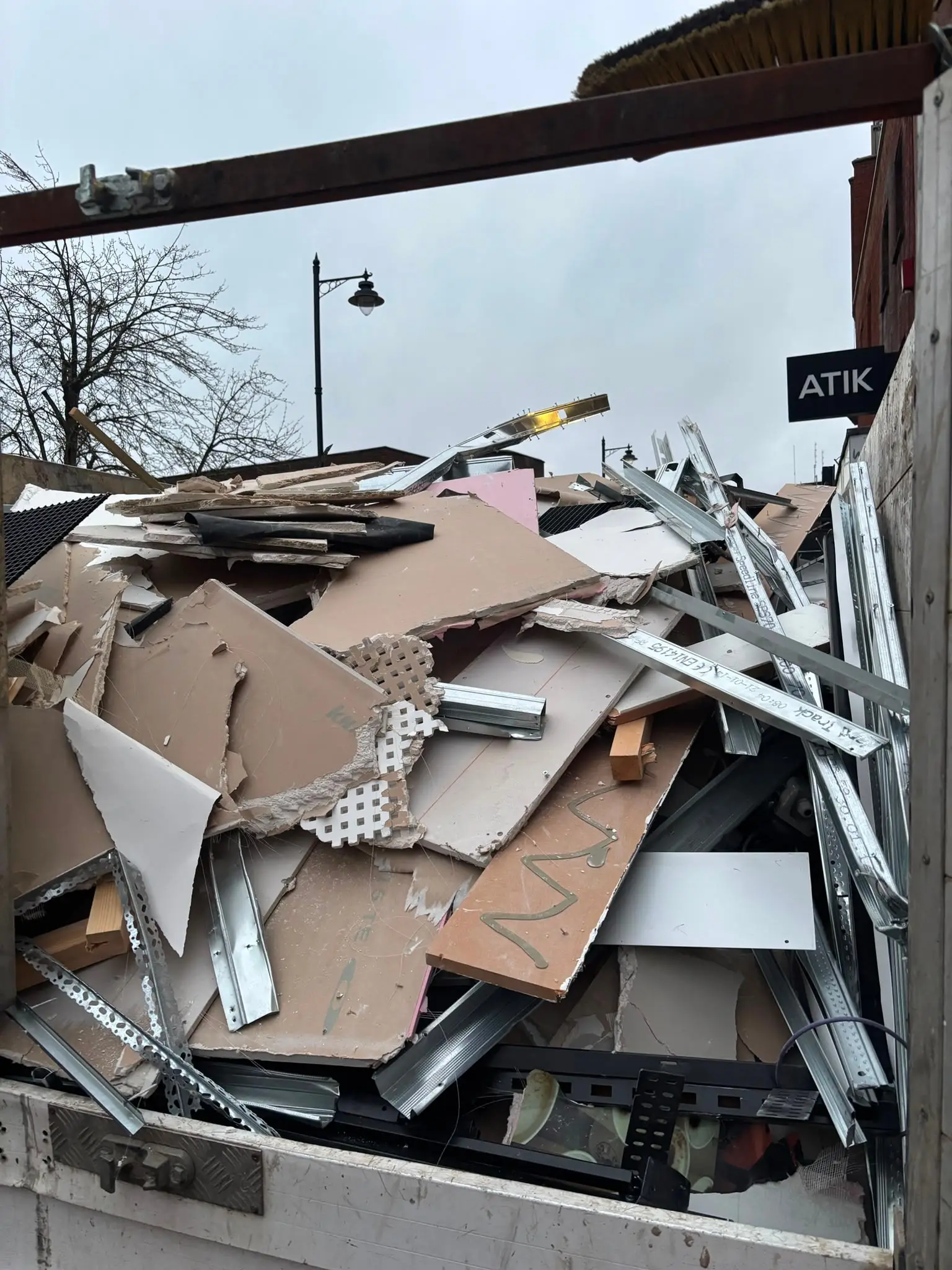 Clearance vehicle loaded with cardboard and bulky waste for removal.